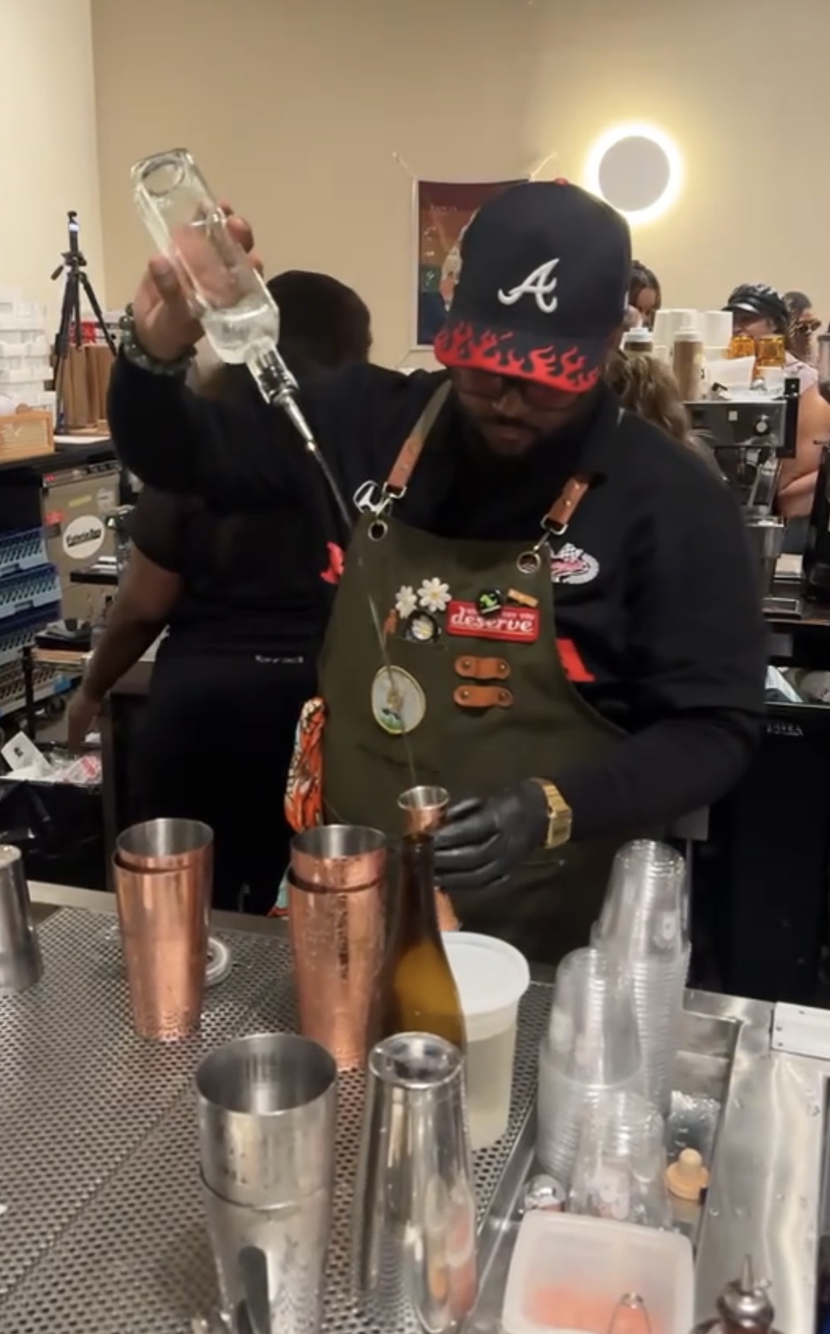 Close-up of an expert bartender meticulously measuring spirits with a jigger for a custom drink.
